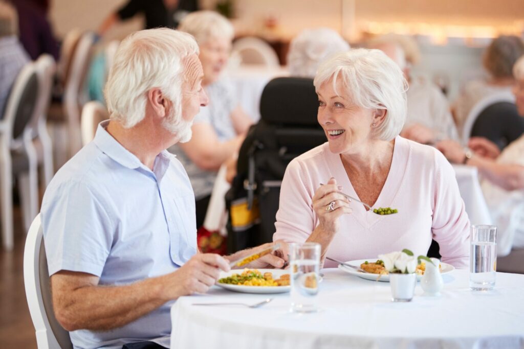 two old people enjoying a meal together.