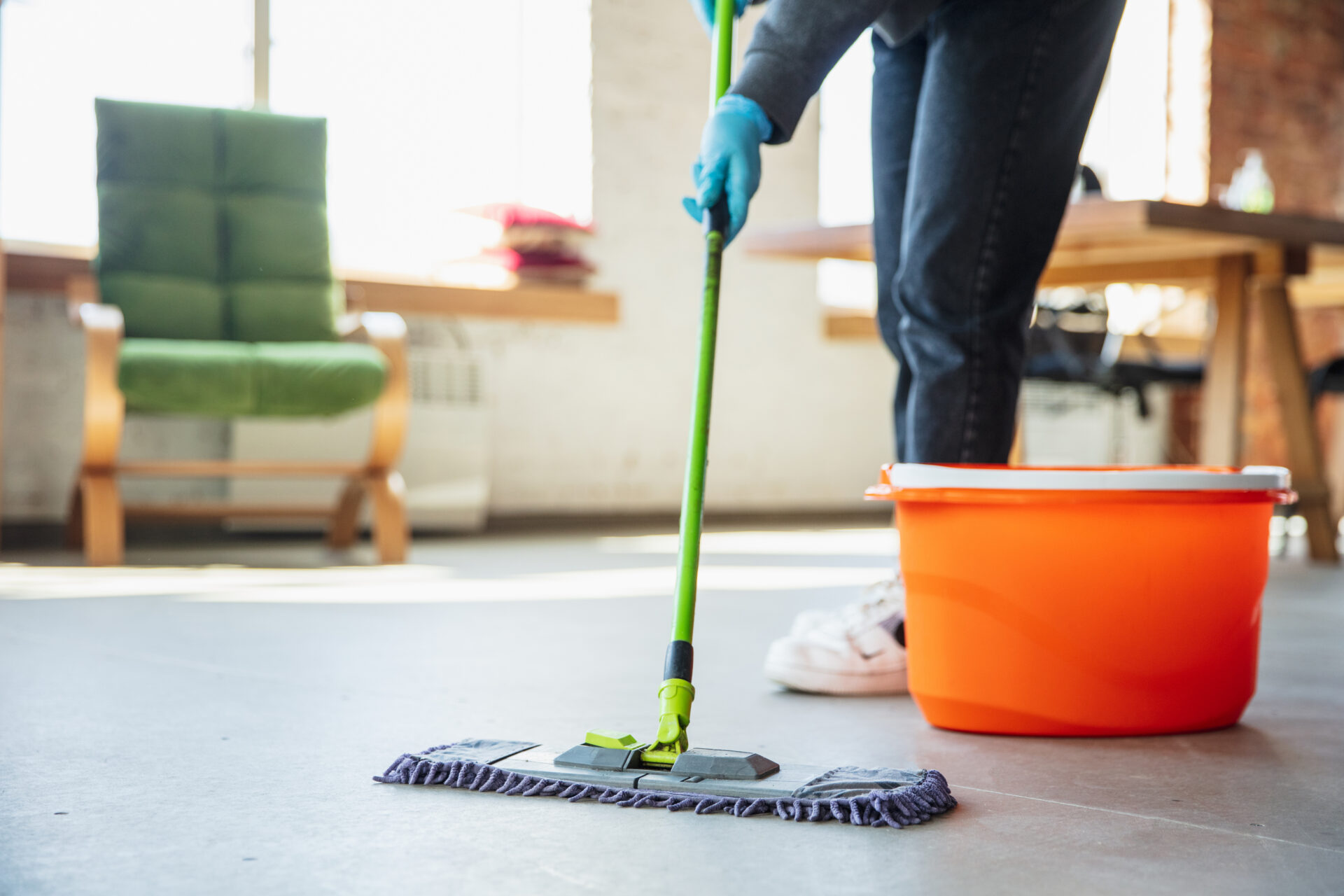 Someone cleaning using a mop and bucket.