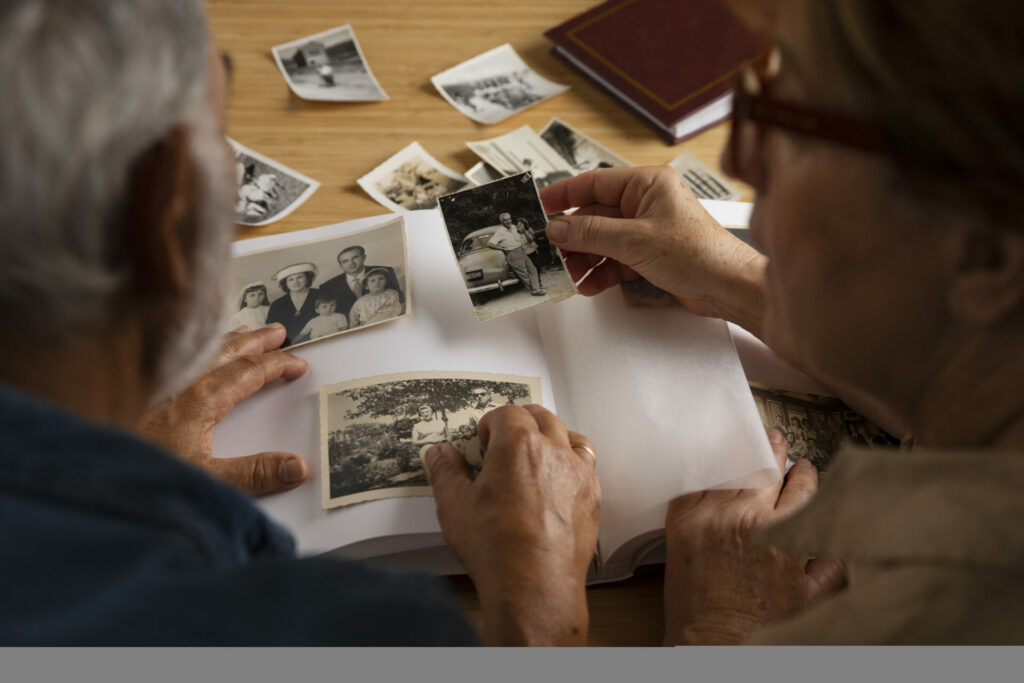 Two people going through a photo album.