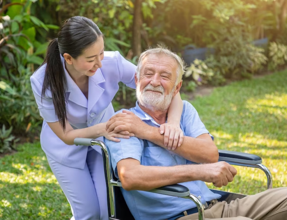 An elderly man appreciating his nurse as she talks to him.