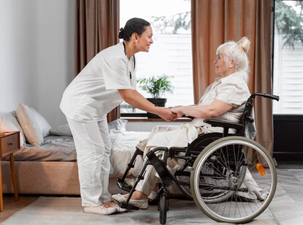 An elderly woman, in a wheelchair being tended to by a nurse.
