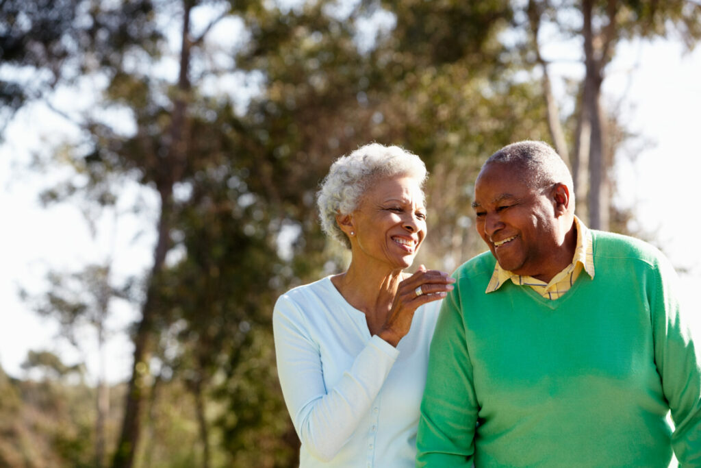 Senior Couple Enjoying Walk Together In The Park